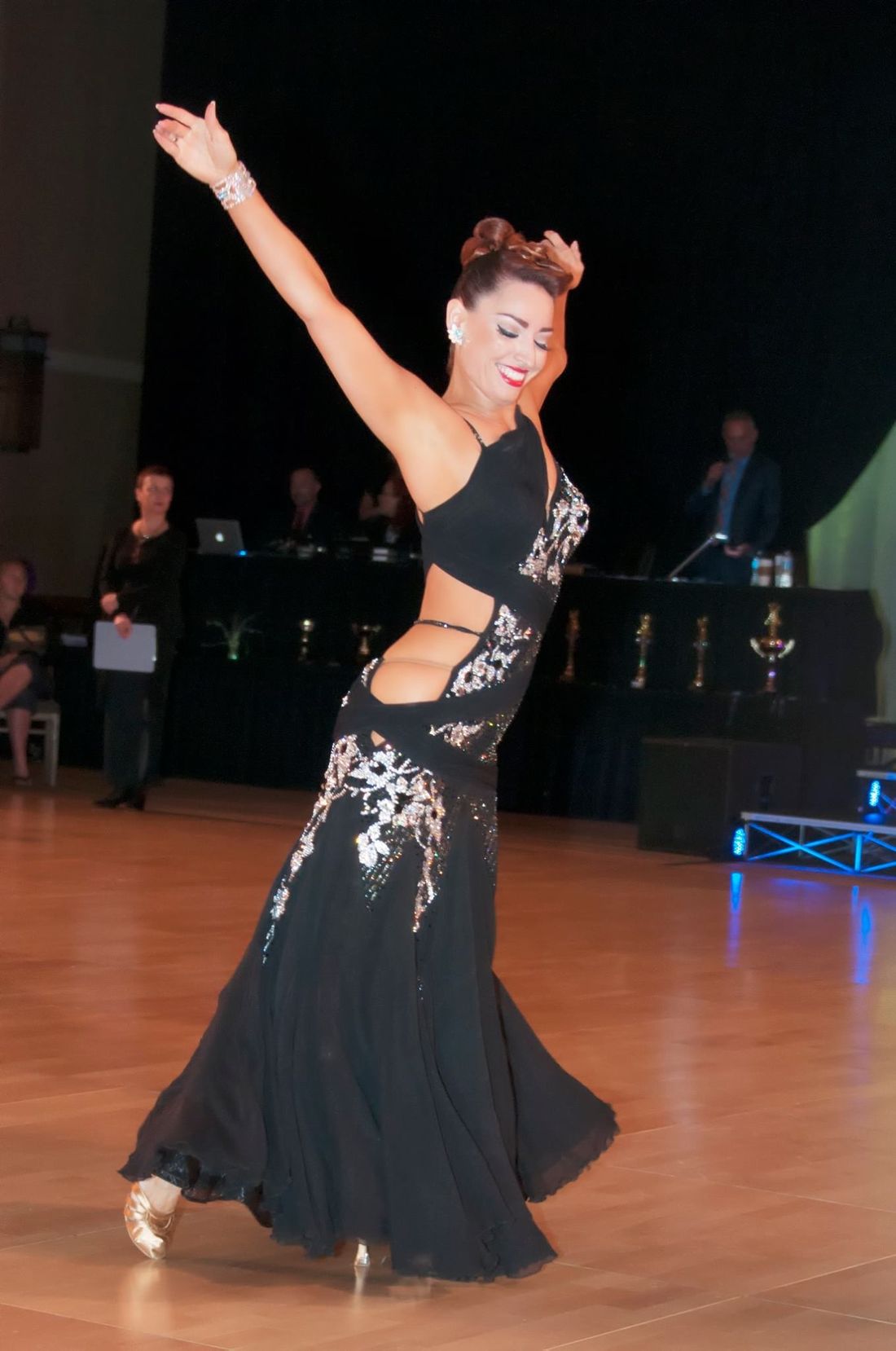 Jaklyn Royal performing a ballroom line in a black competition gown
